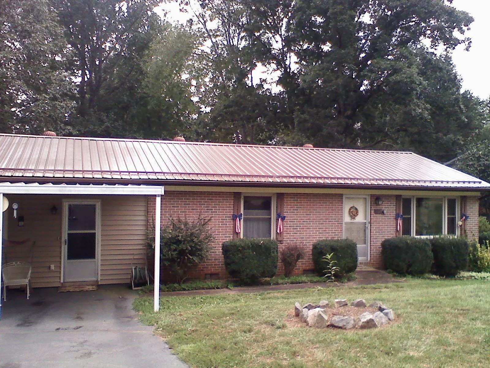 Bronze metal roof and carport on a brick ranch home — Roof Repair work by our crew in San Andreas